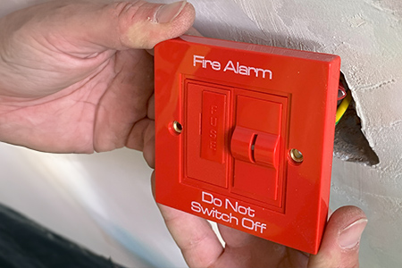 Fire Alarm Being Installed in Fire Door