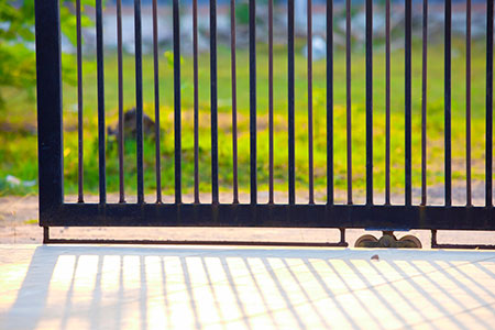 closeup of black electric gate opening