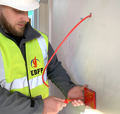 Man Installing Fire Alarm