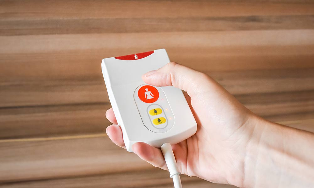 nurse-call-life-safety-services-care-home-img Nurse Call System Button Being Pushed